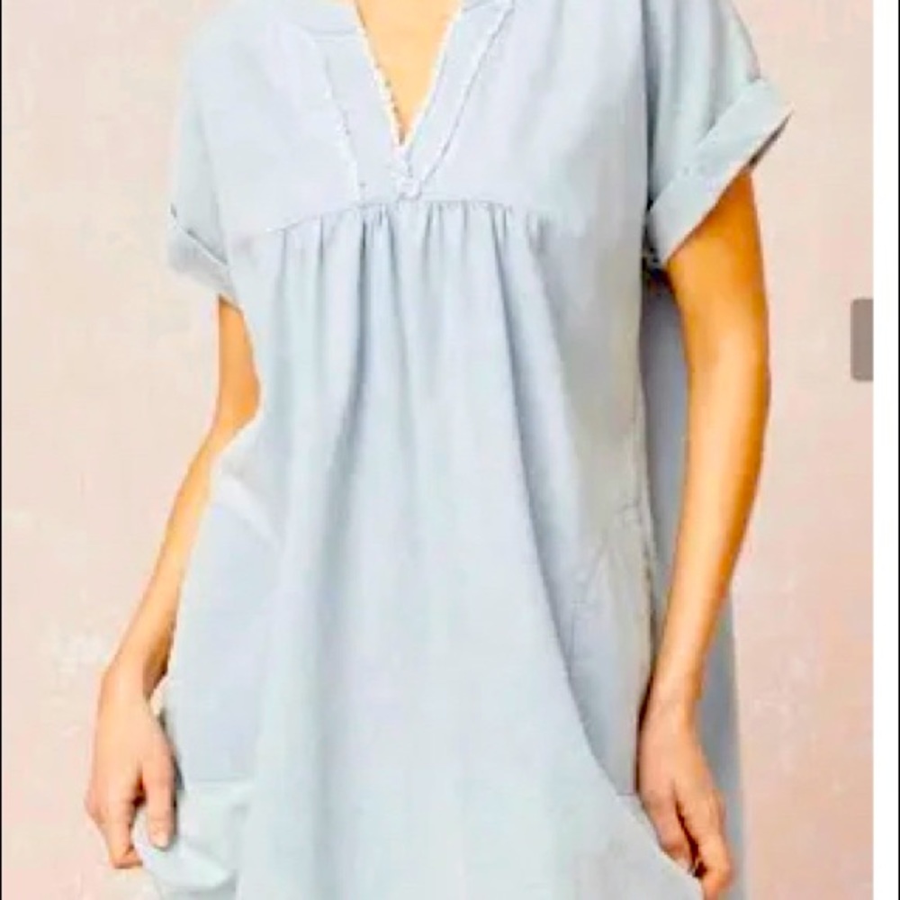 Denim v-neck short sleeve dress. featuring frayed hem detail. Pockets at sides.